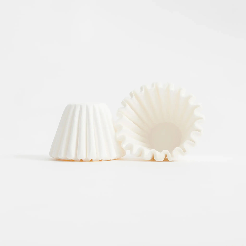 Paper filters to brew Komuna coffee on an Orea brewer