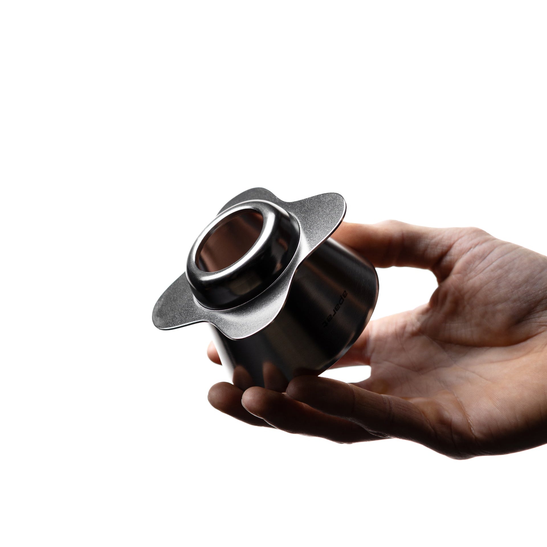Hand pouring coffee from an Orea dripper by Komuna Coffee