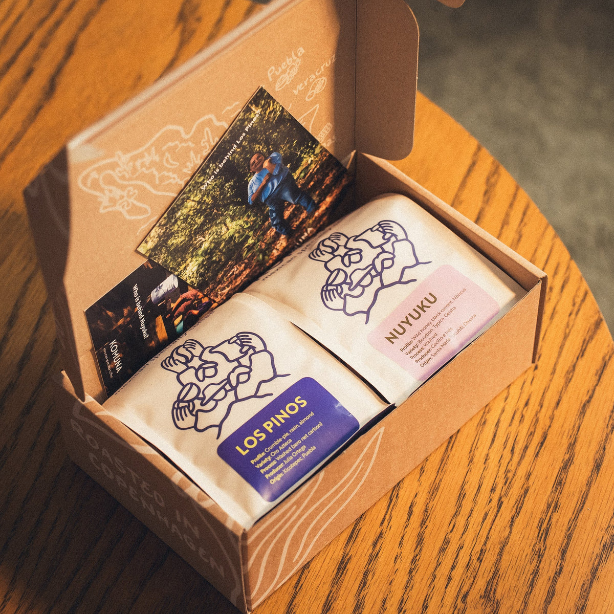 Open box of Komuna mexican specialty coffee subscription